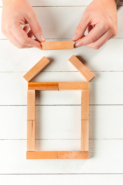 Man and wooden cubes on table. Management and marketing concepts